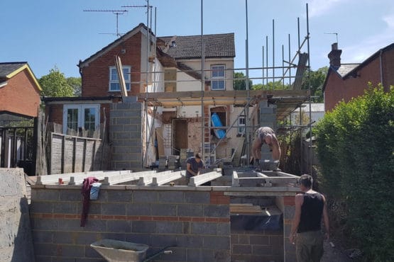 A group of builders working on an extension