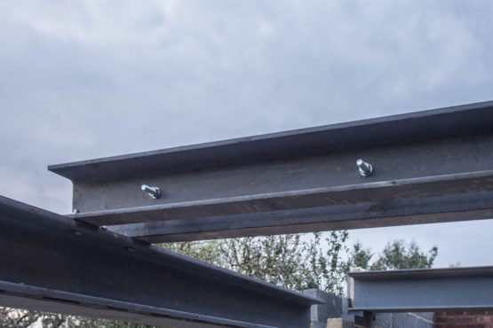 Extension building project showing a close-up of steel support steel beams